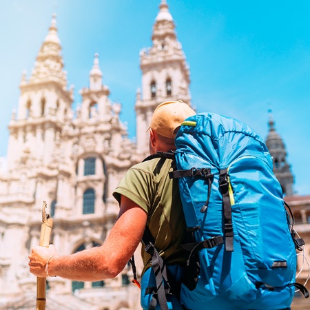 A pilgrim in front of Santiago de Compostela Cathedral