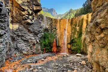 Rainbow colours of the Cascada de Colores in the Caldera de Taburiente National Park on the Island of La Palma, Canary Islands