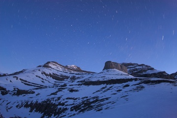 Night view of the snow-capped mountain peaks