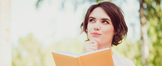Girl with a book looking pensive