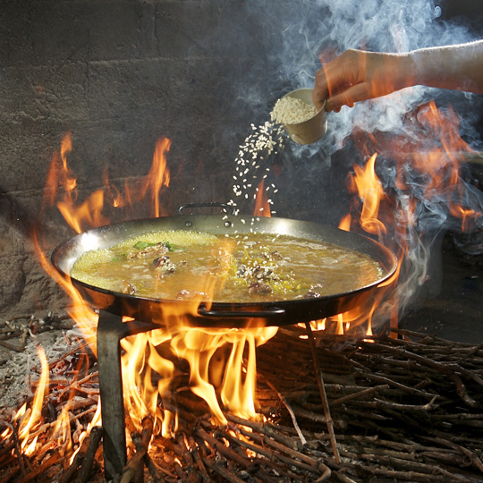 Rice prepared in paella over vine shoots