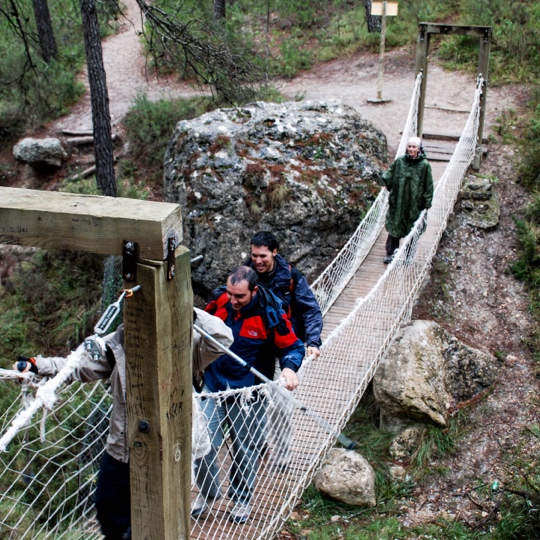 Hikers crossing the hanging bridge on the way to Senda del Dinosaurio, Murcia