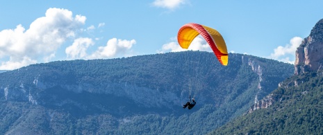 Tourist paragliding in the Organyà area in Lleida, Catalonia