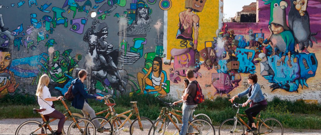 Tourists on an eco-bike street art tour of Barcelona, Catalonia Tourists on an eco-bike street art tour of Barcelona, Catalonia