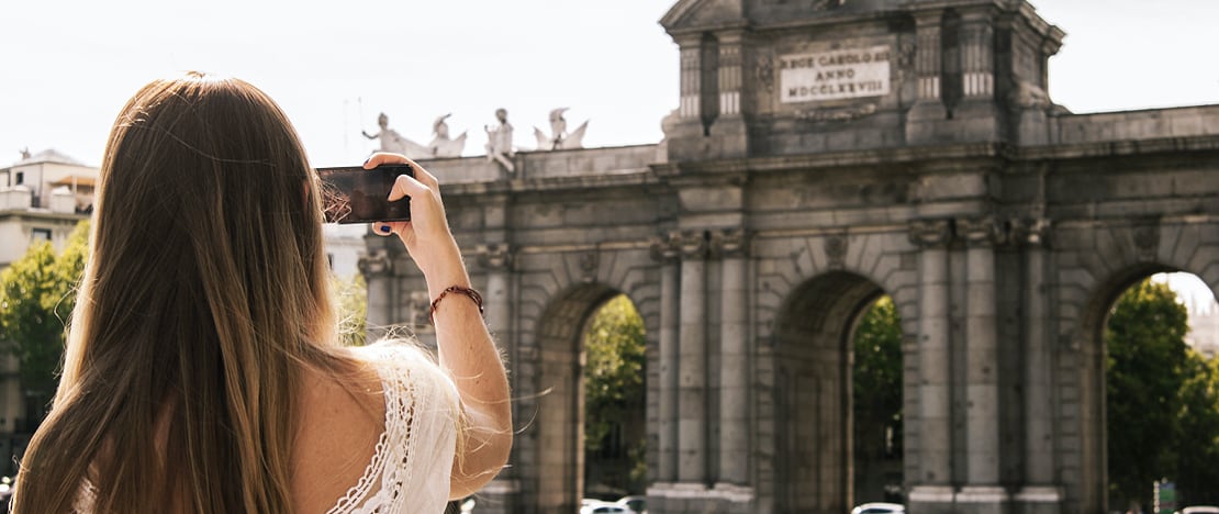 Tourist photographing the Puerta de Alcalá in Madrid, Region of Madrid Tourist photographing the Puerta de Alcalá in Madrid, Region of Madrid